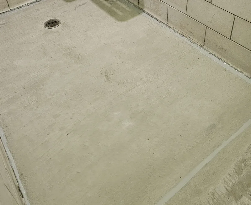Resurfaced concrete floor around its retained drain